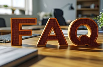 Große FAQ-Buchstaben stehen auf einem sonnigen Schreibtisch neben Pflanzen, was an Informationen des LBV erinnert. | © stock.adobe.com